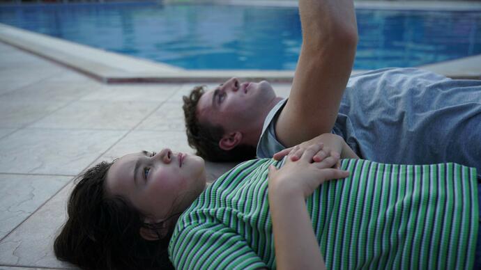 Father and daughter lay on a boat