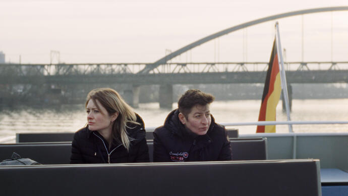 Two women sit on a boat