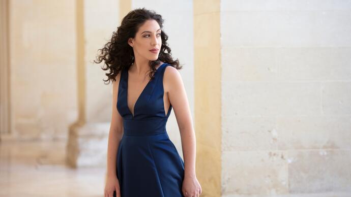 Beatrice Rana in a navy blue dress, looking to her left