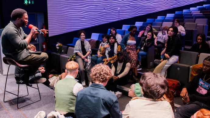 A group of people in a poetry workshop/talk