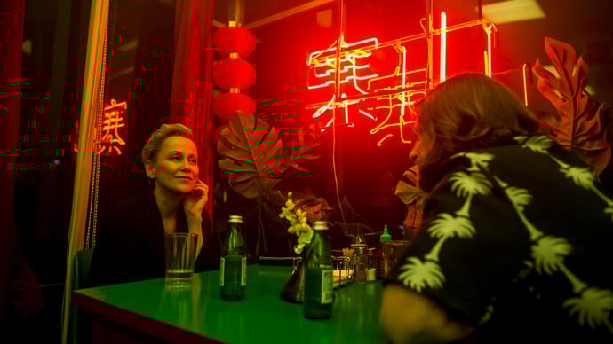 A woman talking with a man in a Chinese restaurant