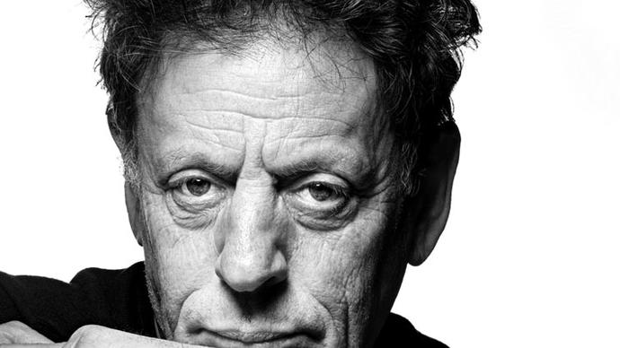a black and white photo of philip glass in london at the barbican centre