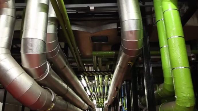 a photo of the barbican centre's engineering room with pipes and other tubes