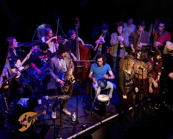Photo of Impossibilities band performing on stage
