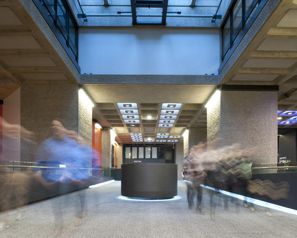 Photo of visitors walking down ramp in Barbican foyers