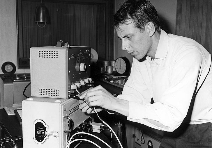 Photo of composer Stockhausen working in the studio
