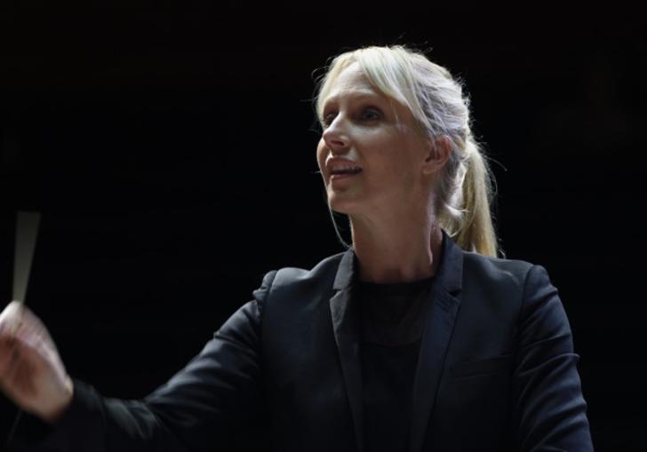 Sofi Jeannin conducting black background