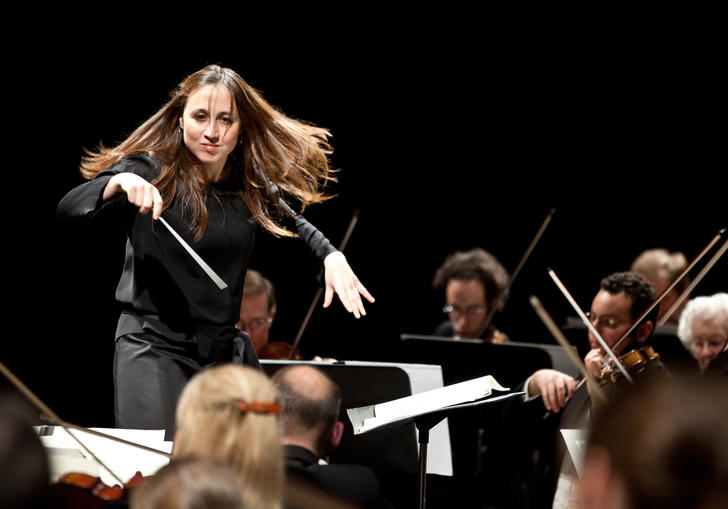 Joana Carneiro conducting on stage landscape