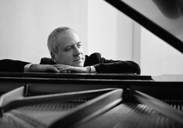 Jeremy Denk sitting at piano landscape B&W