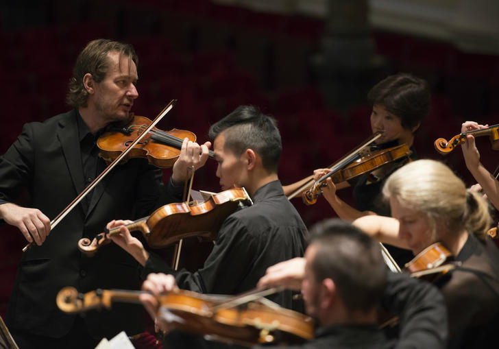 ACO and Tognetti on stage playing