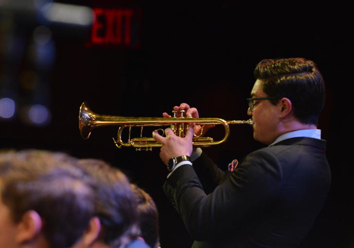 A young Jazz man playing a trumpet