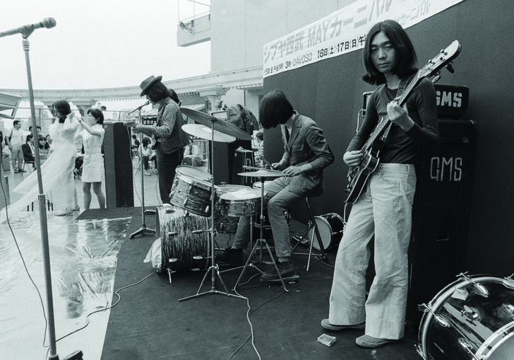 Hosono perform on stage