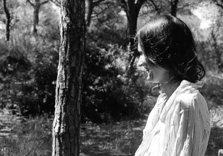 Josephine Foster standing in a wooded area