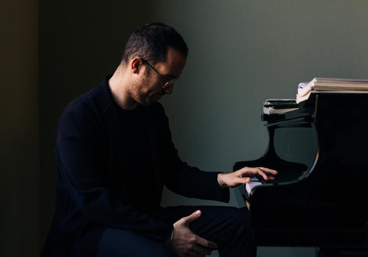 Igor Levit sitting at piano 