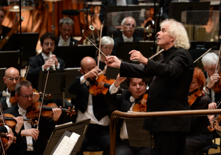 photo of simon rattle conducting