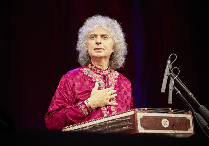 Sivkumar Sharam singing at a podium