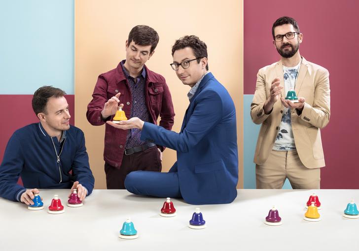 Third Coast Percussion wearing colourful suits playing with colourful handbells