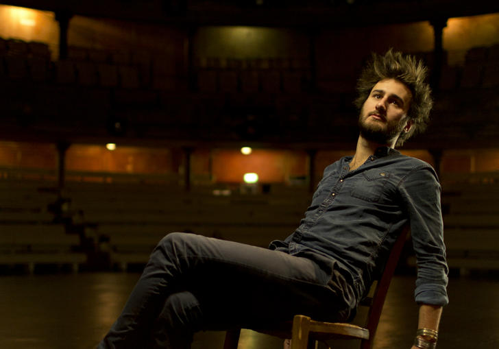 Jean Rondeauc leaning on chair on stage portrait