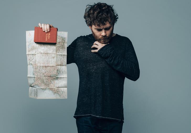 Gabriel Kahane holds up a map of North America