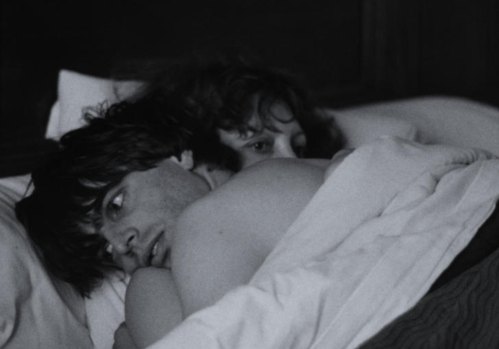 Photo of a couple embracing in bed