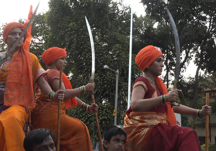 Woman carrying blades in a procession