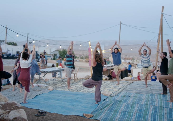 A group doing yoga in the open air.