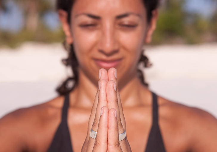 A person pushing their hands together in a yoga pose