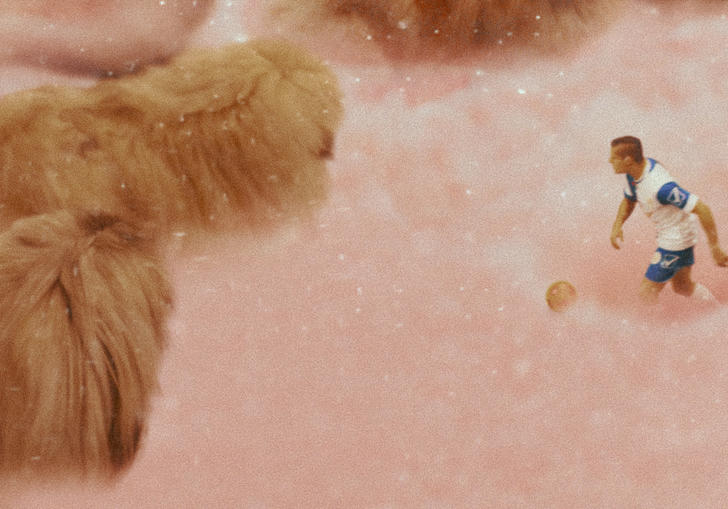 A small footballer wading through pink fluff