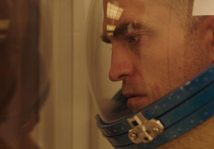 A close up of Robert Pattinson in astronaut gear