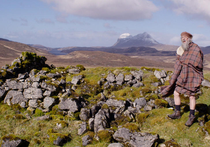 Man in kilt standing on a hill