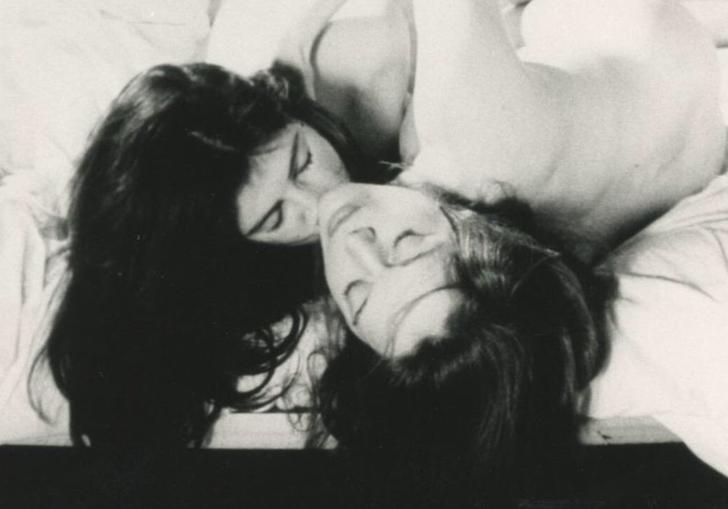 two people embracing in the bed