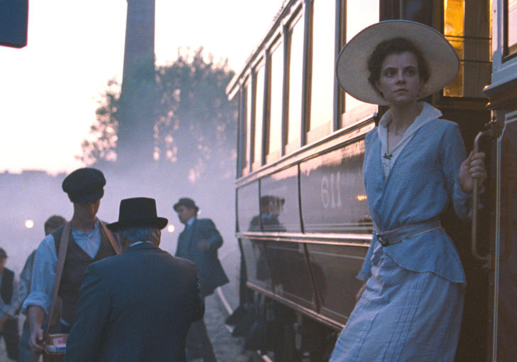 Woman standing by a train
