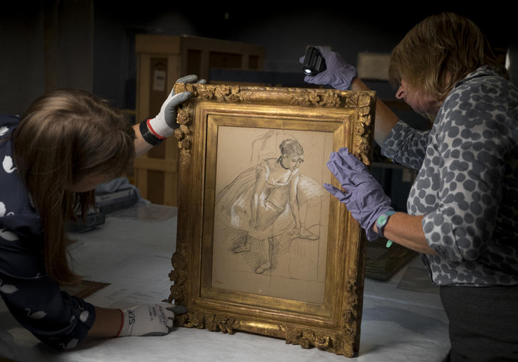 woman looking at painting