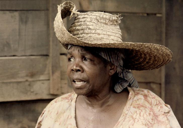 An image of Darling Légitimus in Sugar Cane Alley, wearing a wide-brim hat 