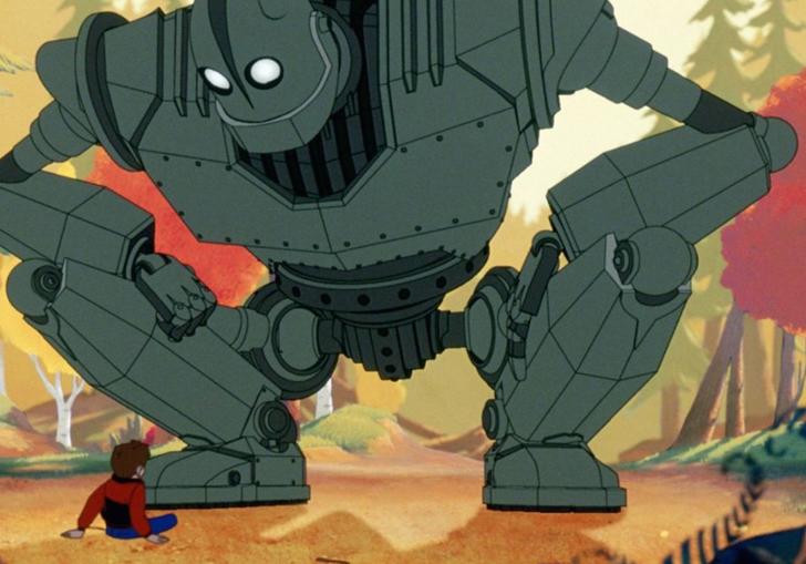 the iron giant crouching over a young boy