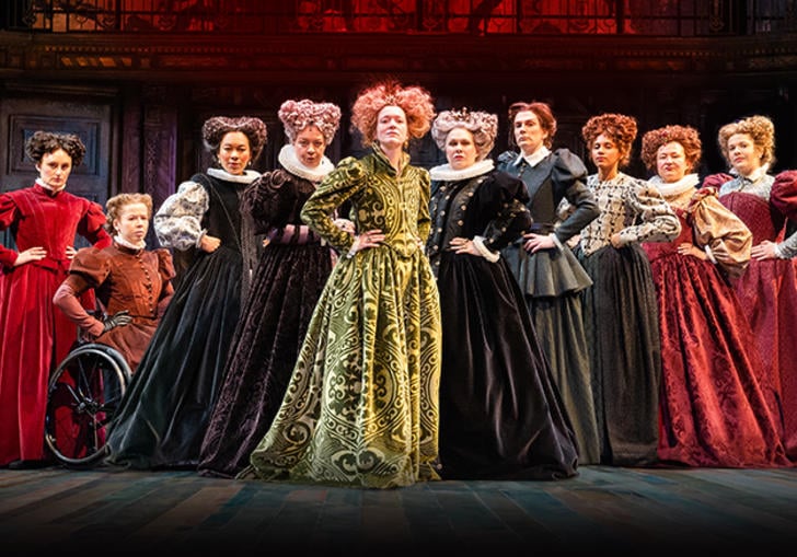 A collection of 10 female cast hold empowered poses on stage