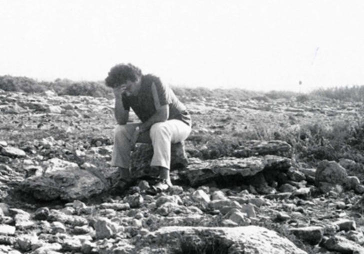 Man sitting in a deserted plain