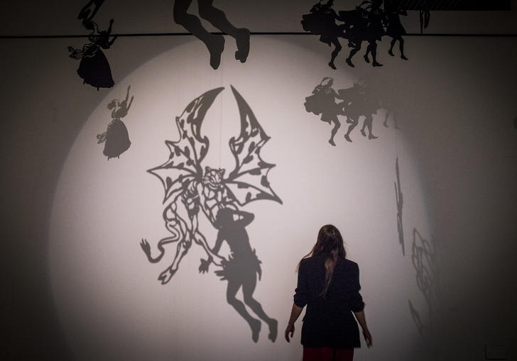 Silhouette of woman in a room full of shadows