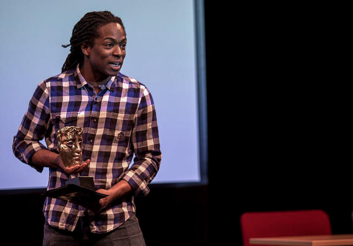 Nigel Clarke holding a BAFTA award