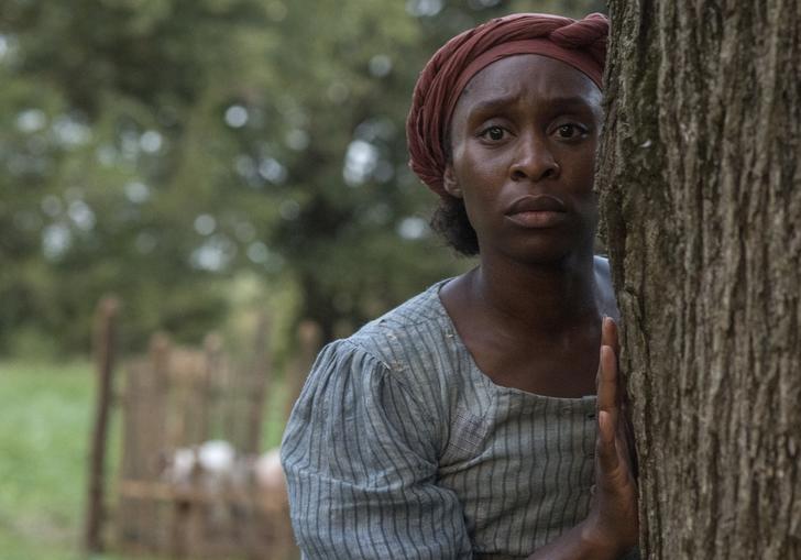 Cynthia Erivo as Harriet hiding behind a tree