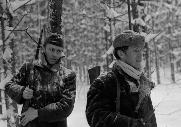 Two Russian soldiers walk through snowy woods in The Ascent