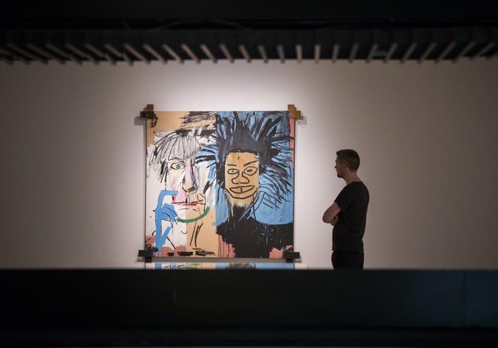Man looking at Basquiat painting