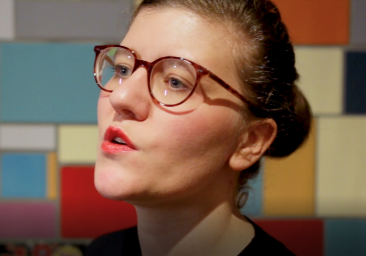 photo of a woman wearing glasses talking to the camera