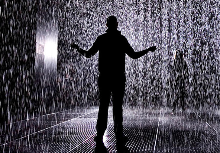 Man standing in a room full of rain