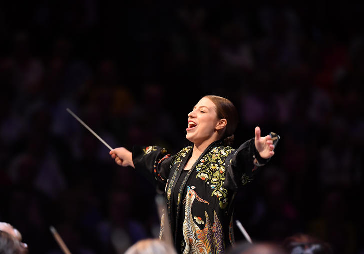 Dalia's arms outstretched as she conducts