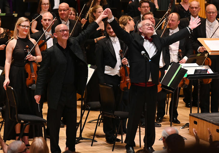 An image of Rutter and Chilcott jubilant, with their arms raised in salutation