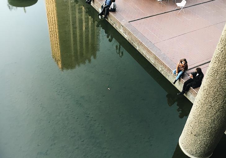 People sitting by the lakeside