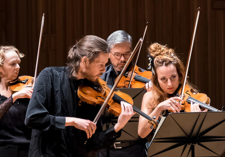 An image of the Britten Sinfonia musicians playing their instruments 