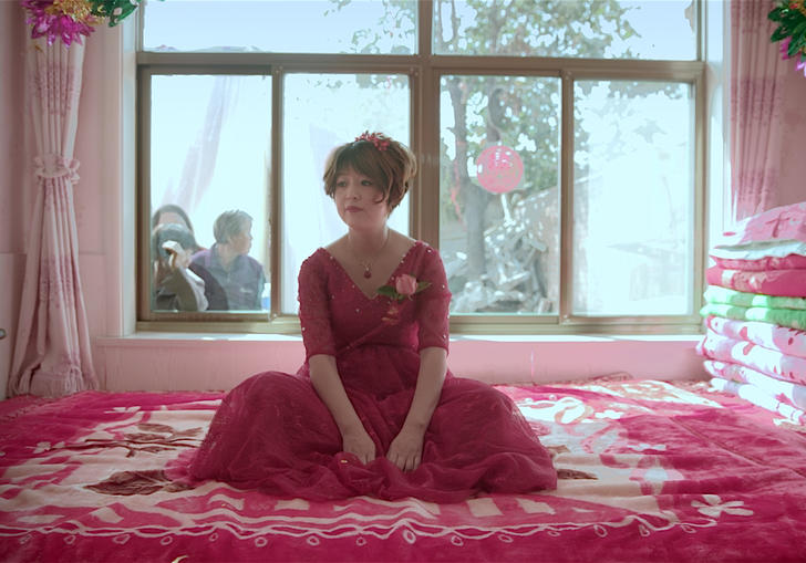 A woman dressed in pink on her wedding day