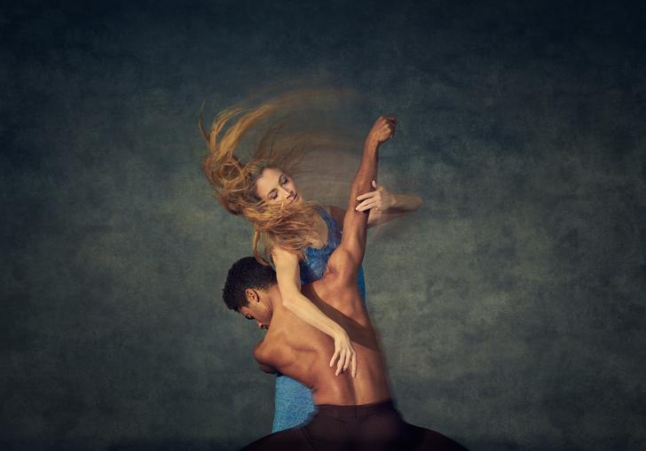 a man and woman with long hair intertwine themselves in dance